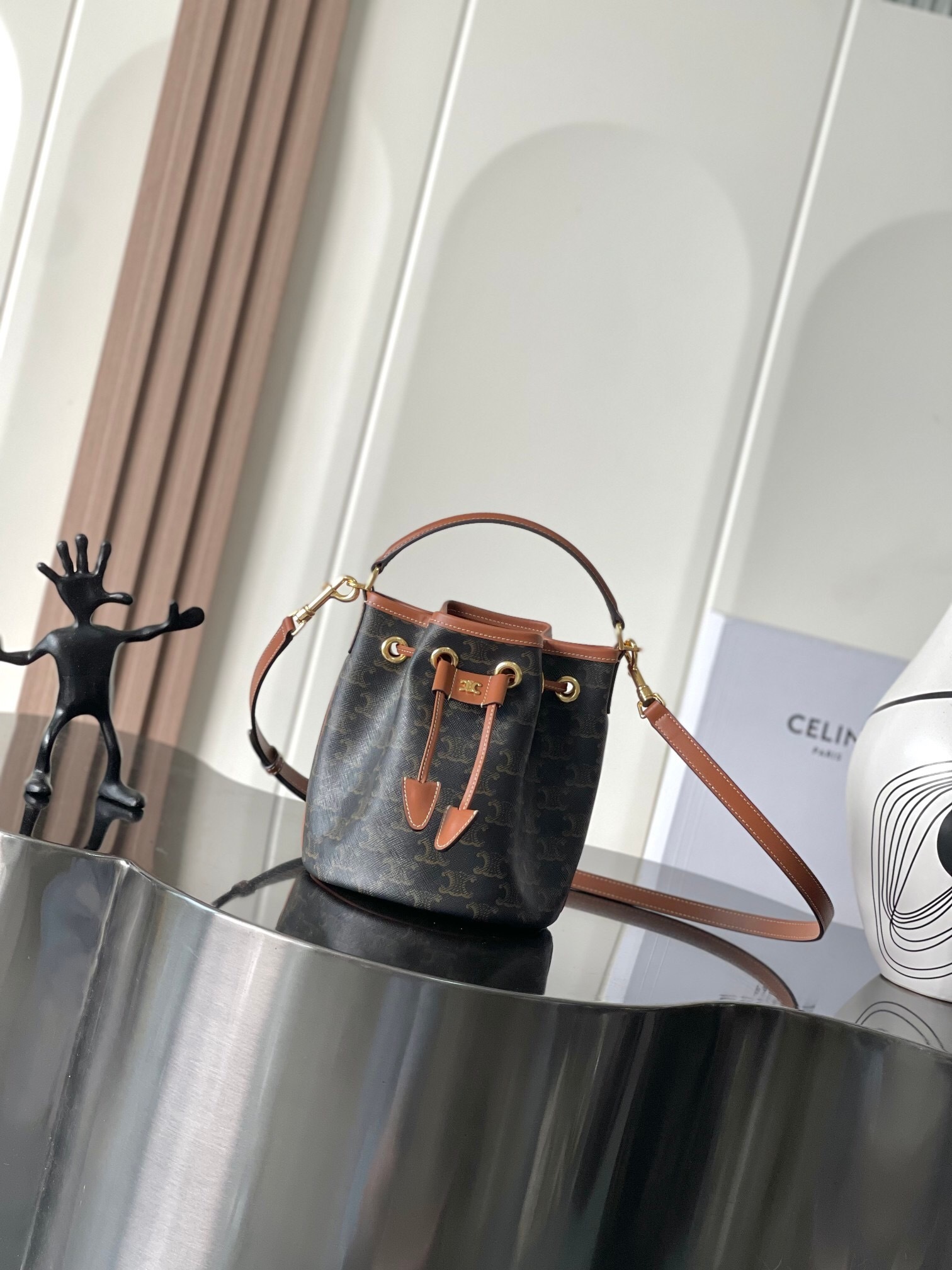 Celine Clara Drawstring Bucket Bag in black Triomphe canvas and tan calfskin leather