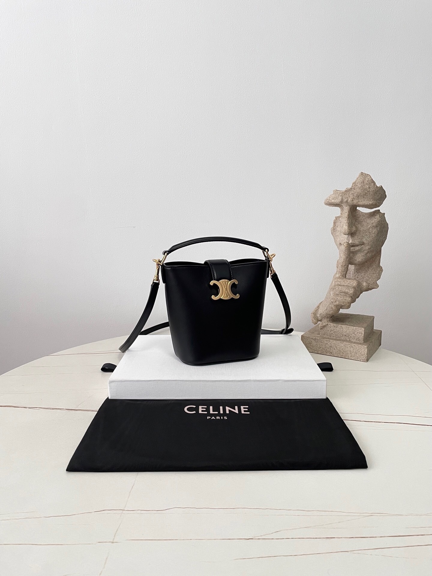 Celine Teen Bucket Bag in black leather with a Triomphe metallic closure