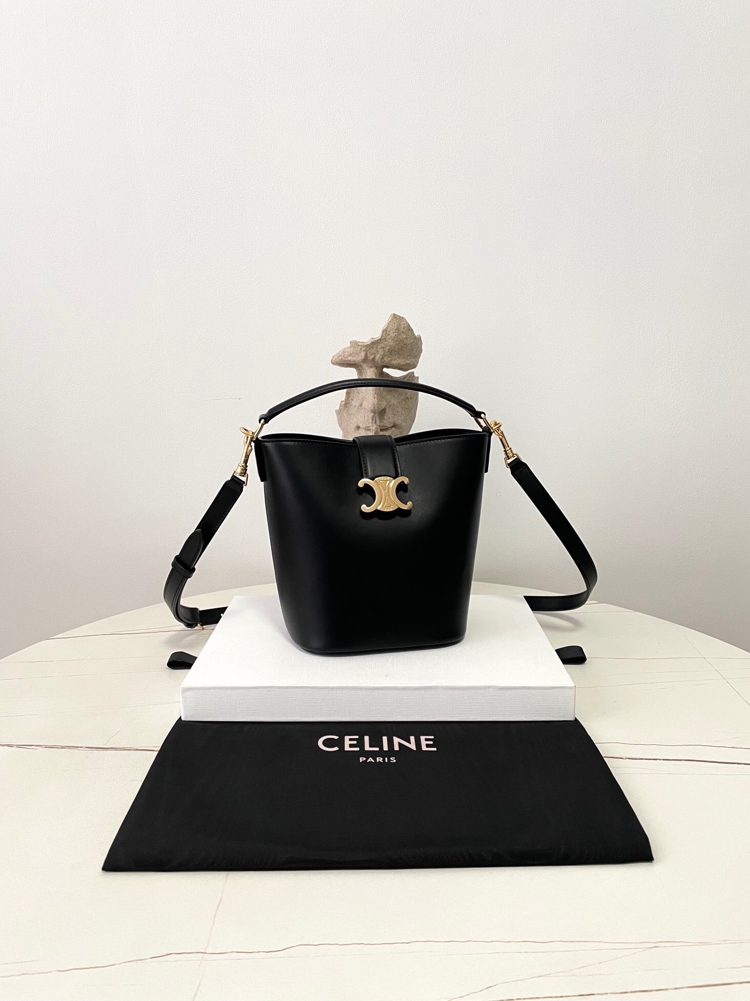 Celine Medium Louise bucket bag in black smooth calfskin with gold-tone hardware and a Triomphe magnetic closure