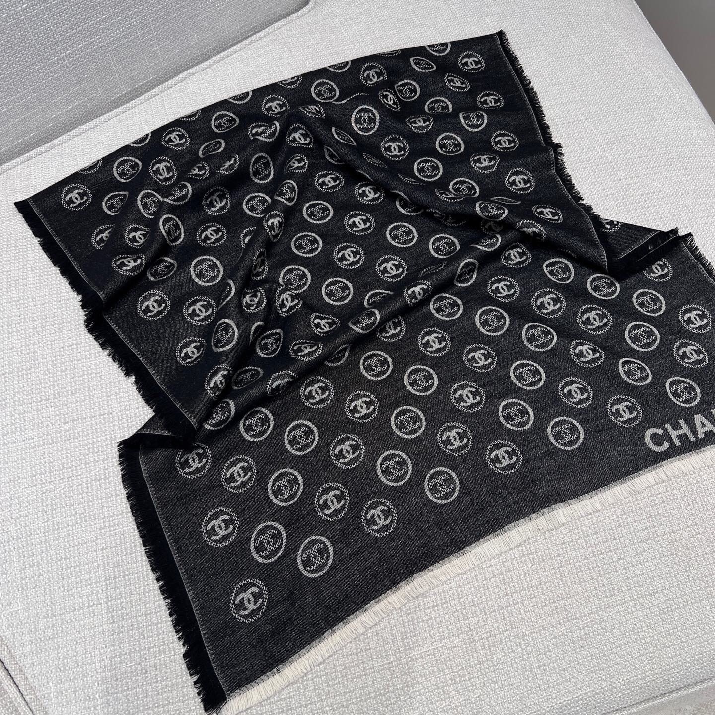 Chanel scarf featuring the brand's iconic interlocking "CC" logo black and white