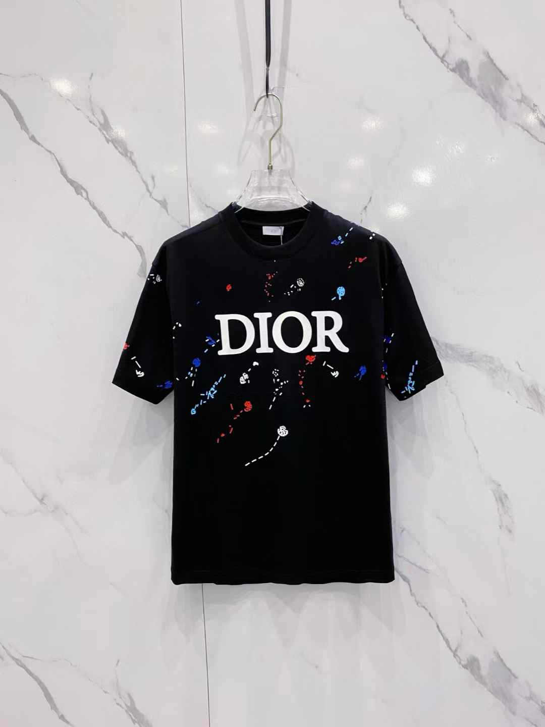 Dior Black T-shirt with a white logo and colorful paint splatter graphics