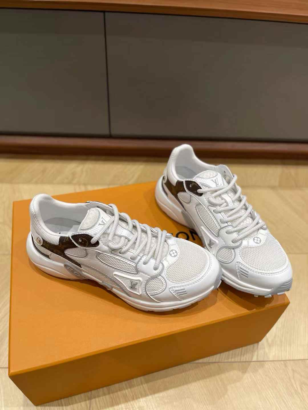 LV Olympia sneaker in white and brown, constructed from a mix of mesh, synthetic leather, and Monogram canvas.