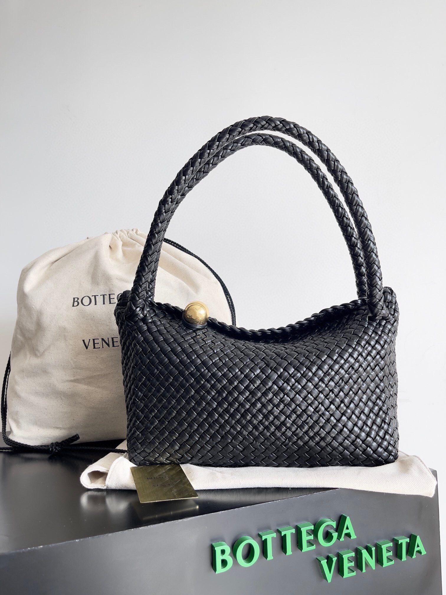Bottega Veneta Tosca shoulder bag in black intrecciato leather with a sculptural brass sphere