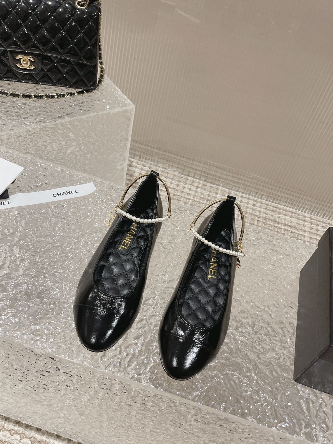 Chanel ballerina flats with a pearl and gold chain ankle strap