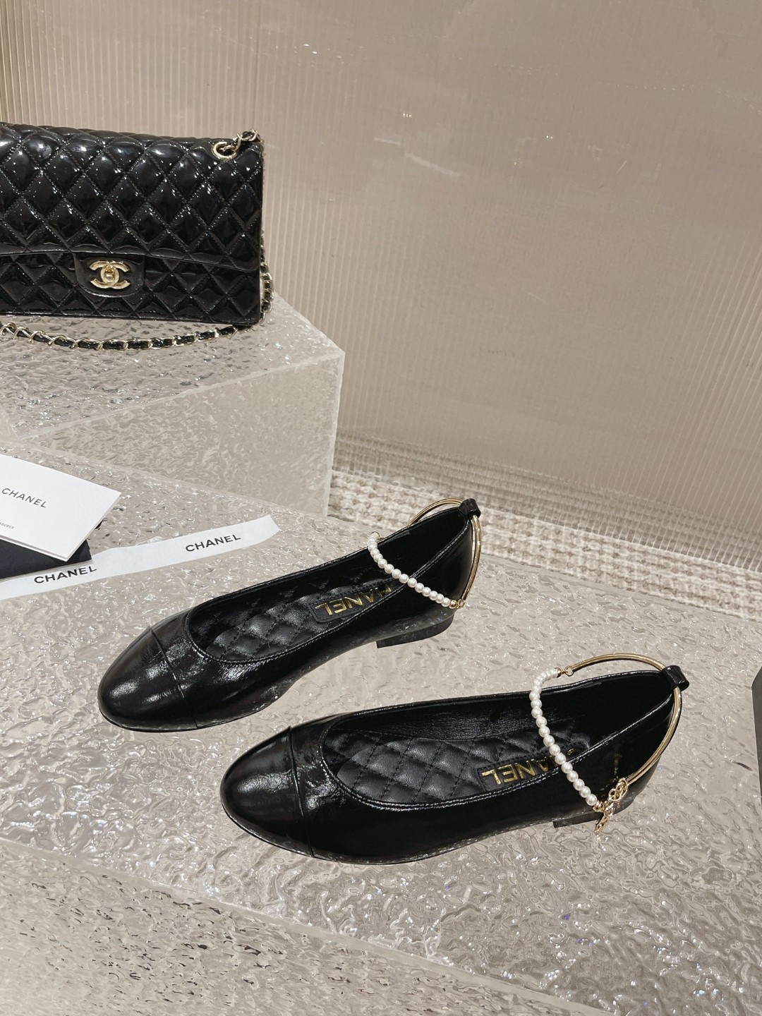 Chanel ballerina flats with a pearl and gold chain ankle strap