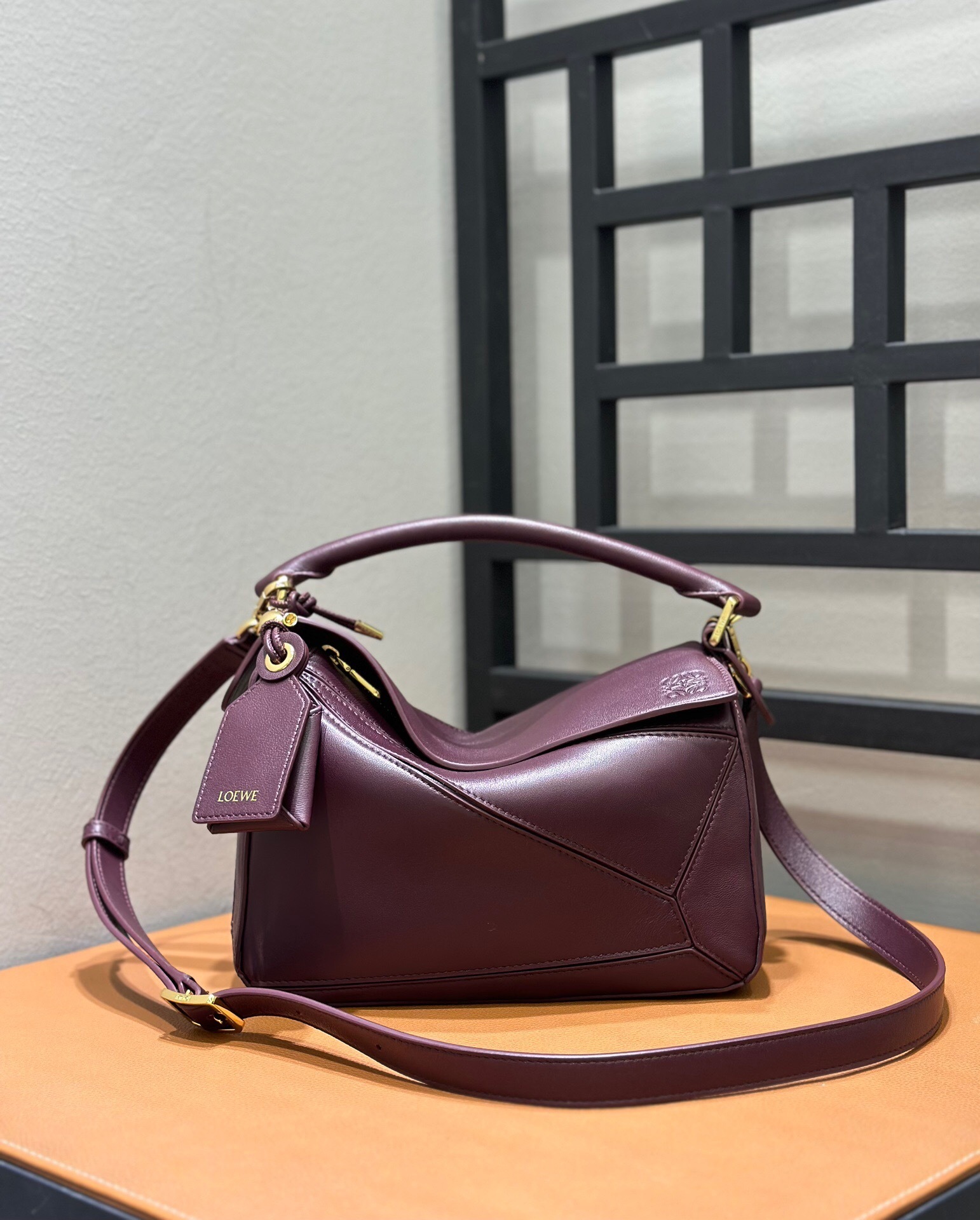 Loewe Puzzle bag in a deep burgundy or plum color