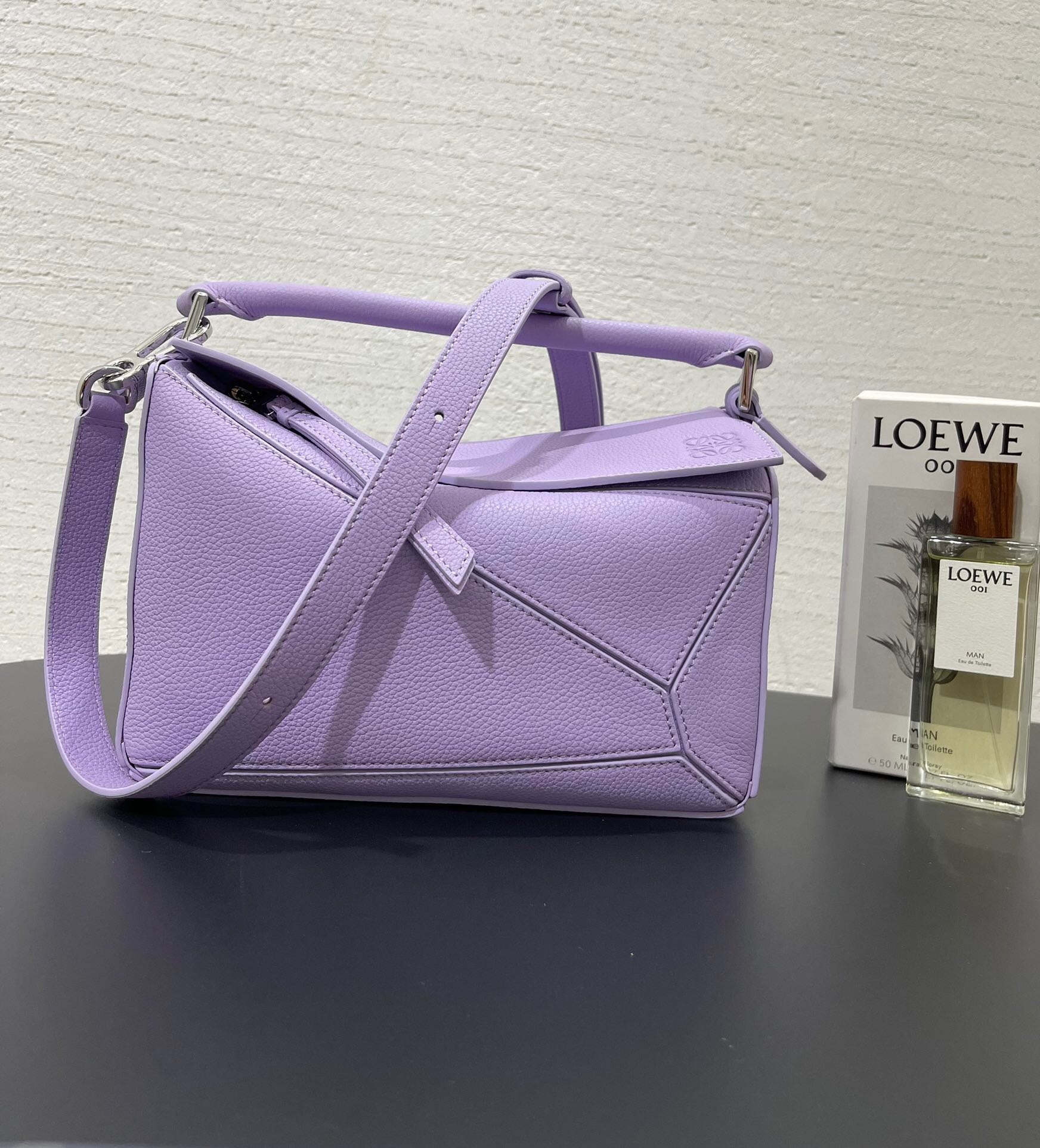 Loewe Mini Puzzle bag in soft grained calfskin leather and light mauve or violet color