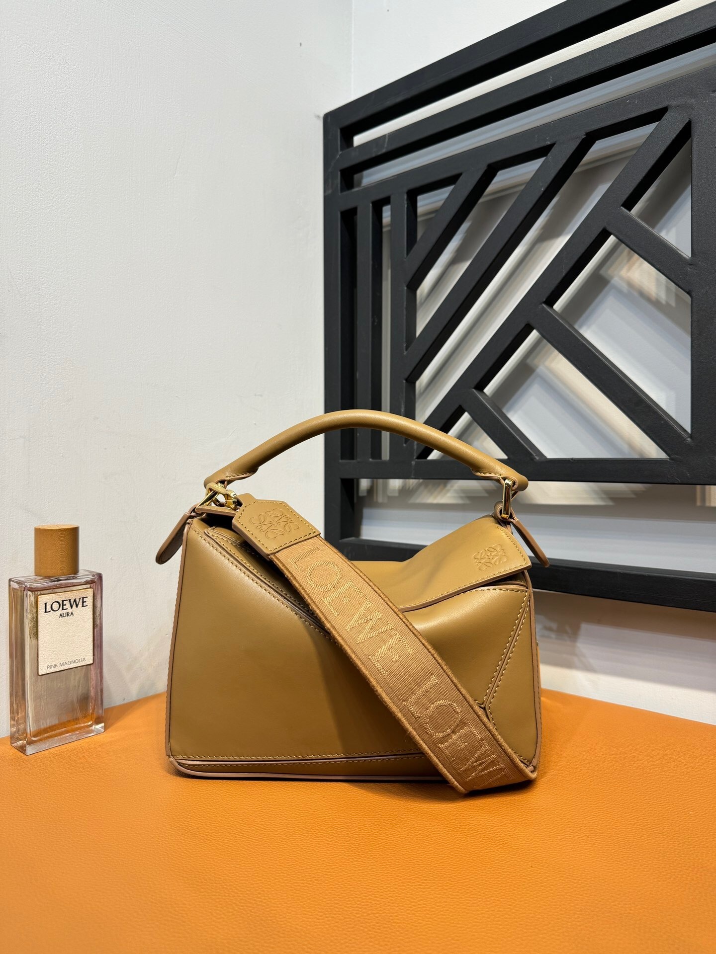 Loewe Puzzle bag in a tan or camel-colored leather with a logo-jacquard strap