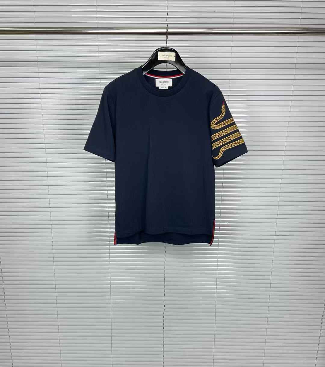 thom browne men's navy blue T-shirt with a snake-like print on the sleeve