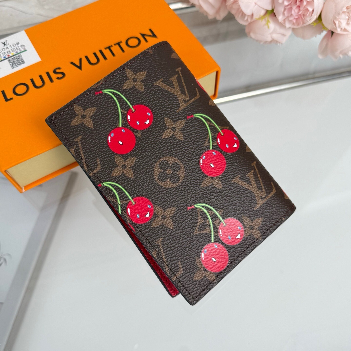 LV  x Takashi Murakami Cherry Passport Cover in monogram canvas with red cowhide leather lining.