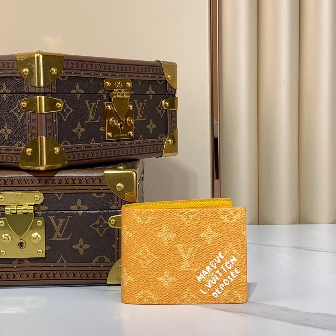 LV men's wallet in a yellow-orange color with a monogram pattern and "MARQUE L.VUITTON DEPOSÉE" text