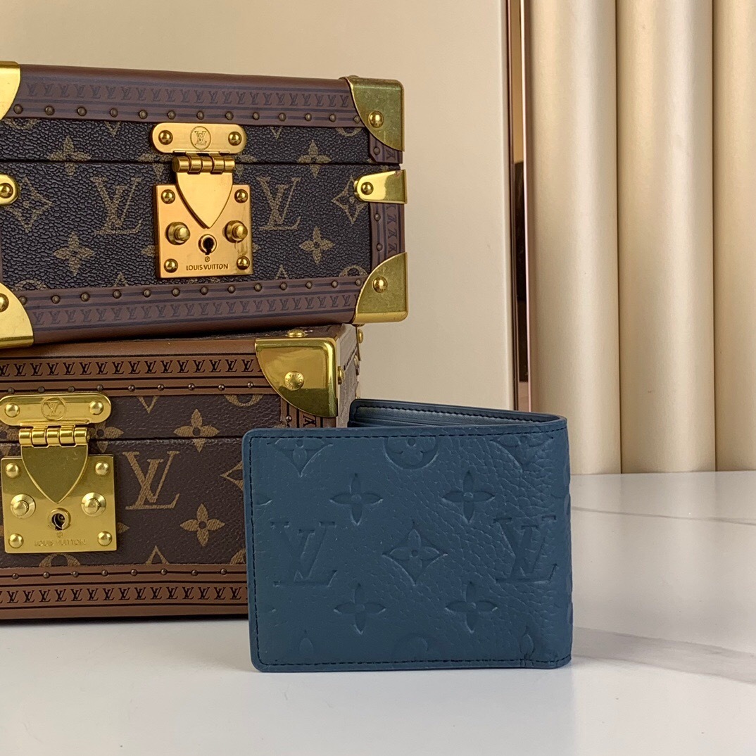 LV Multiple Wallet in a blue shade Taurillon or calf leather with discreet Monogram embossing.