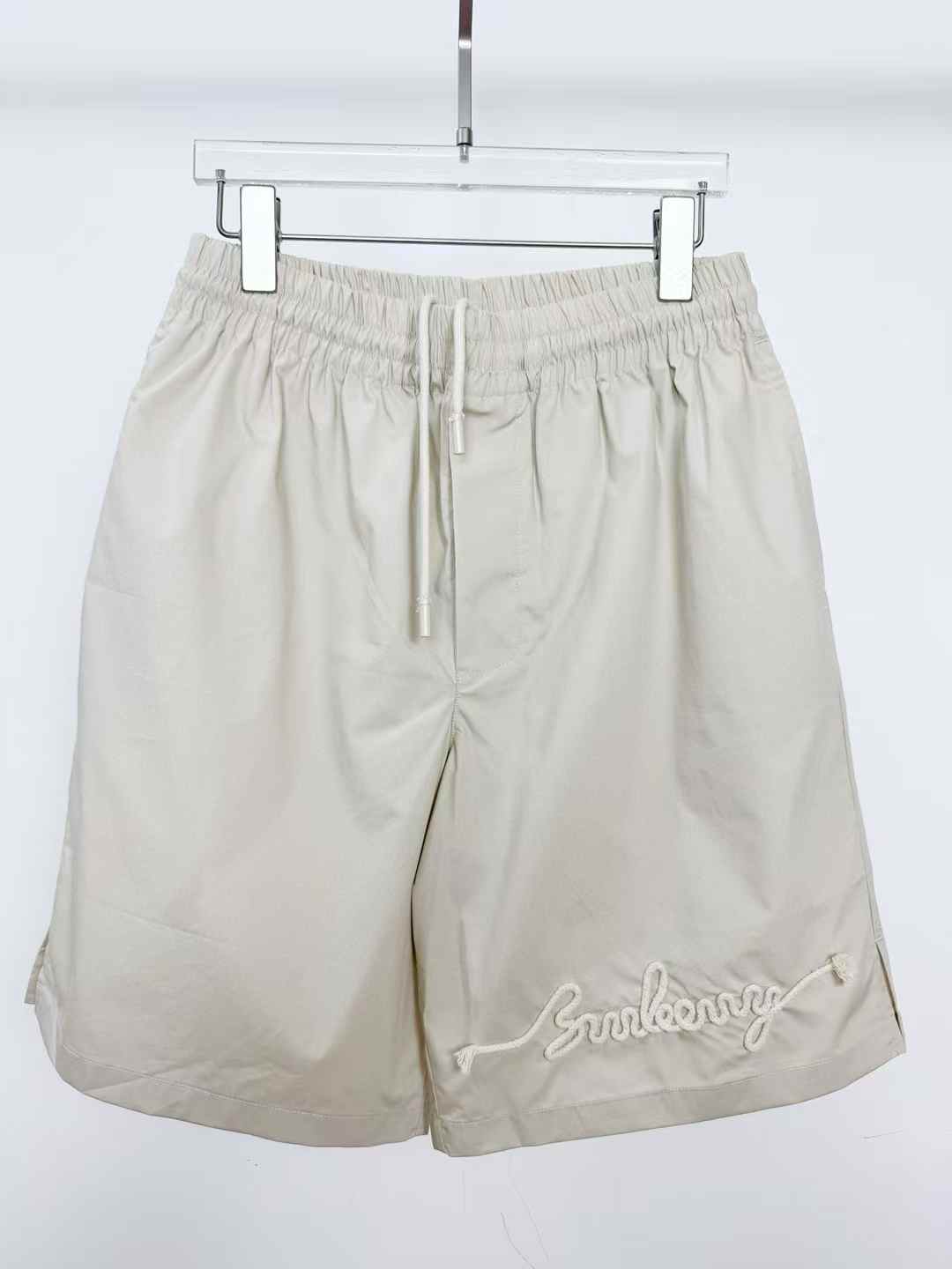 Burberry Relaxed Fit Cotton Shorts in a light color with an embroidered logo on the leg