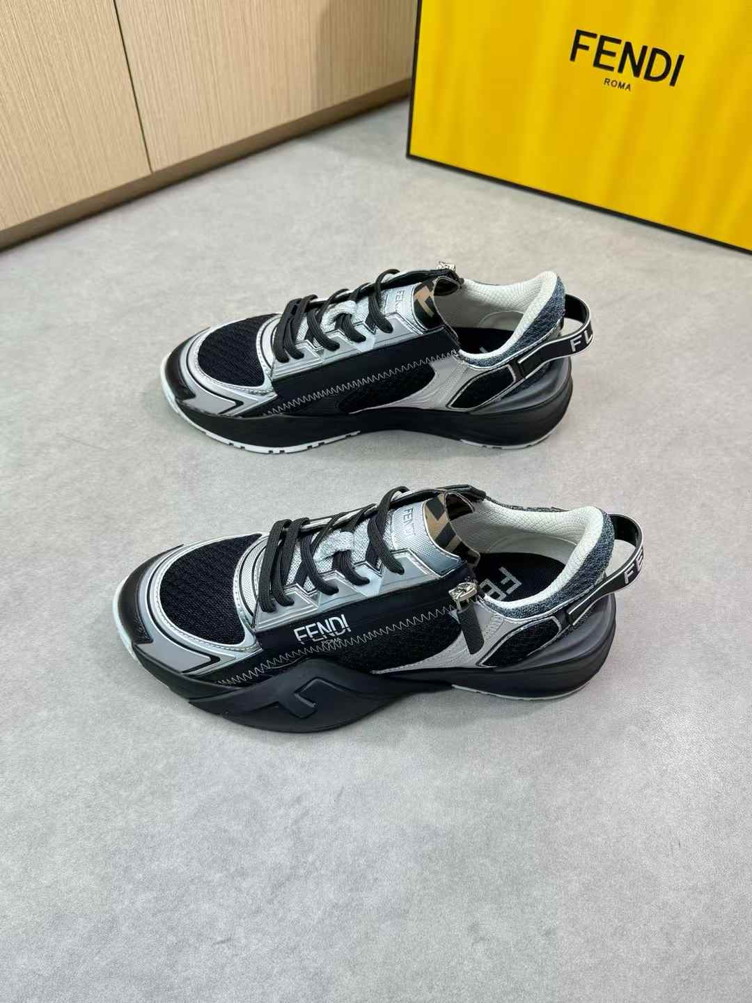 Fendi Flow sneakers in black leather and FF fabric inserts