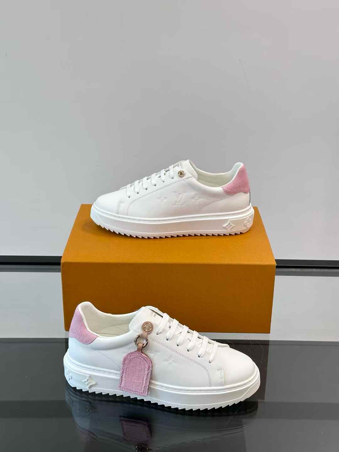 LV Time Out sneaker in white and pink calf leather with a luggage-style label