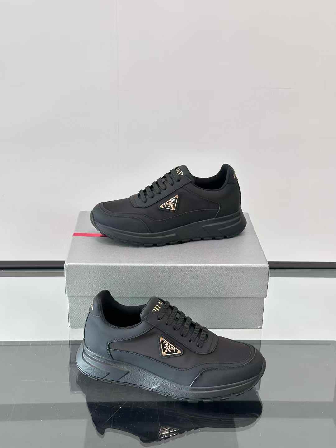 Prada low-top sneakers featuring the enamel triangle logo black
