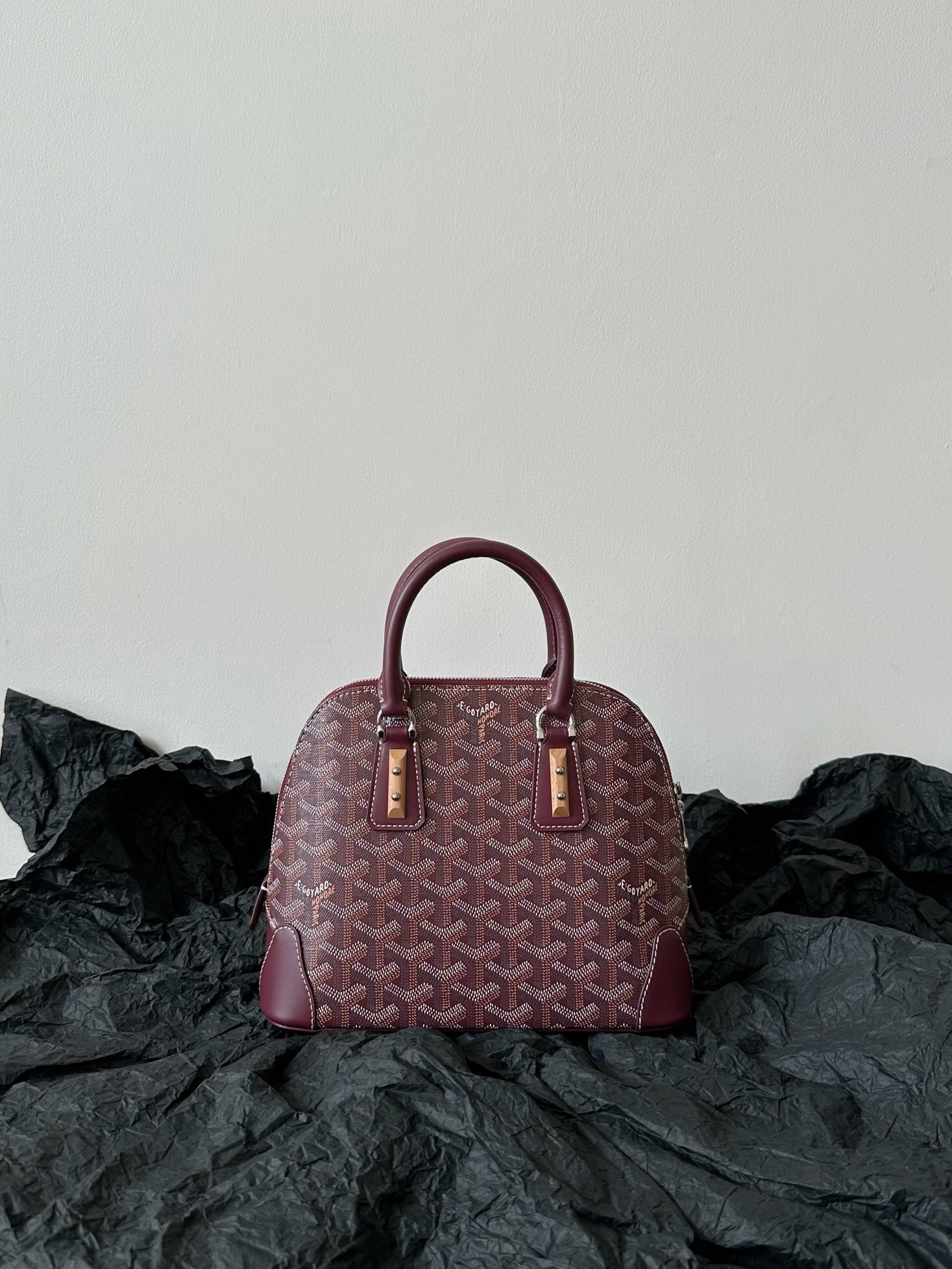 Goyardine Mini Vendôme handbag in a burgundy color