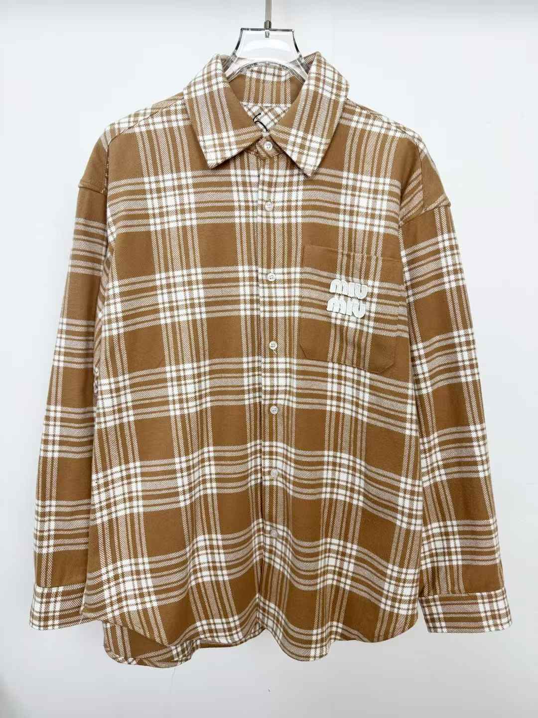 Miu Miu brown and white plaid flannel shirt with a logo on the chest pocket