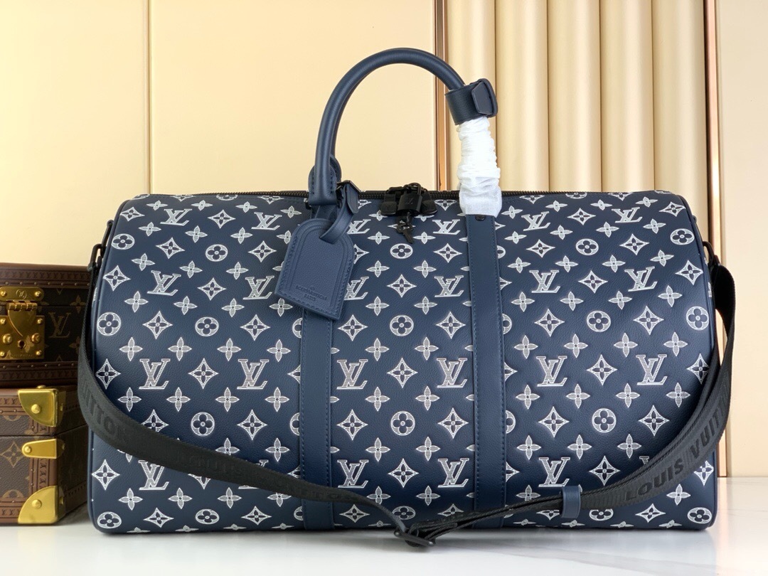LV Keepall Bandoulière 50 duffel bag in blue leather with an embossed Monogram pattern