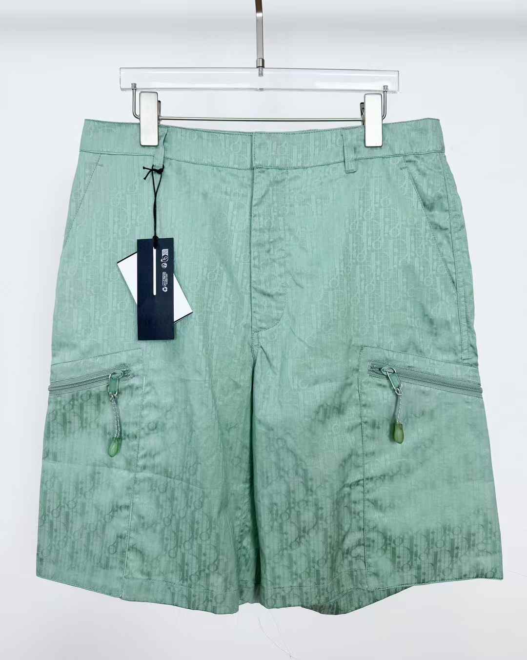 christian dior green shorts polyester- and cotton-blend twill with a logo and gradient pattern print throughout.