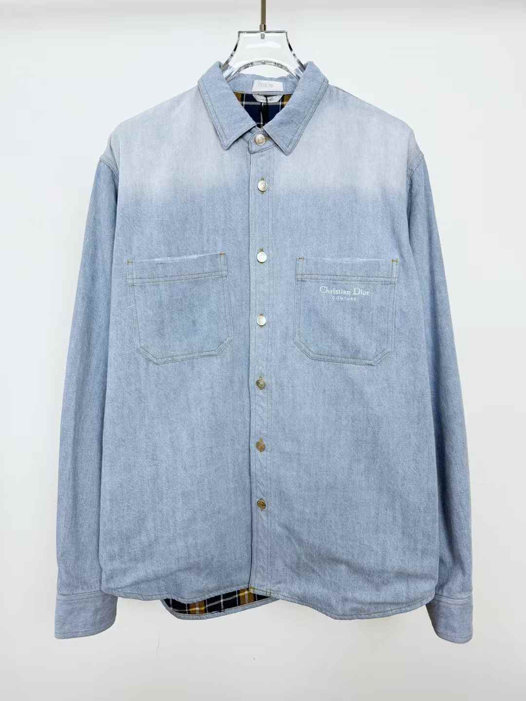 christian dior Our Legacy denim shirt with a faded wash and a subtle plaid lining visible at the hem