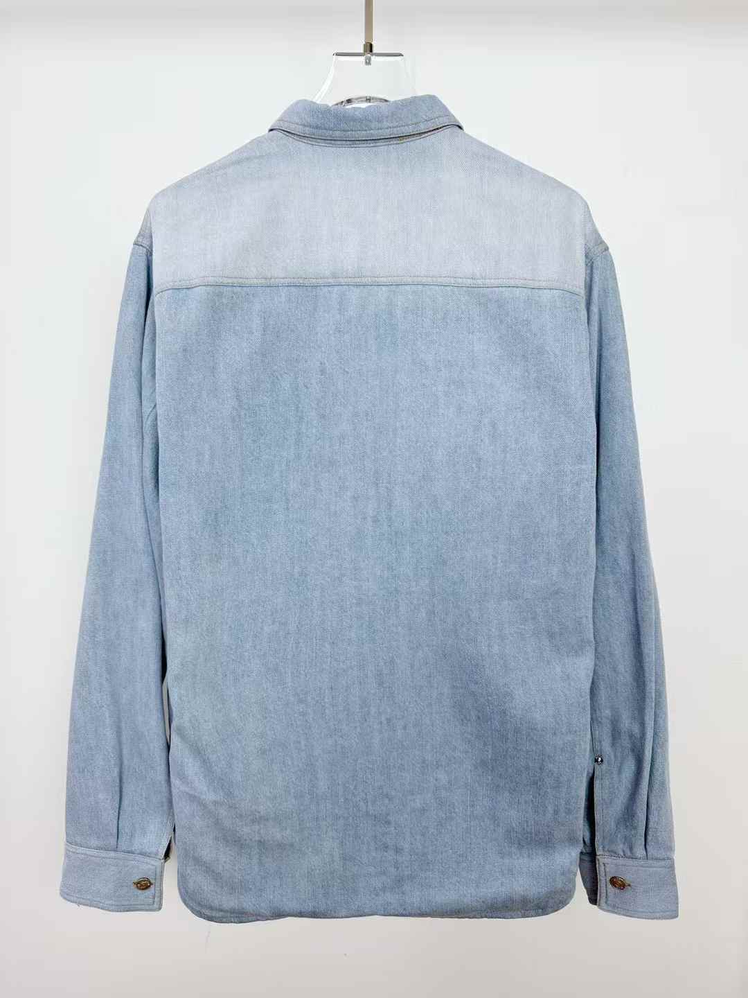 christian dior Our Legacy denim shirt with a faded wash and a subtle plaid lining visible at the hem