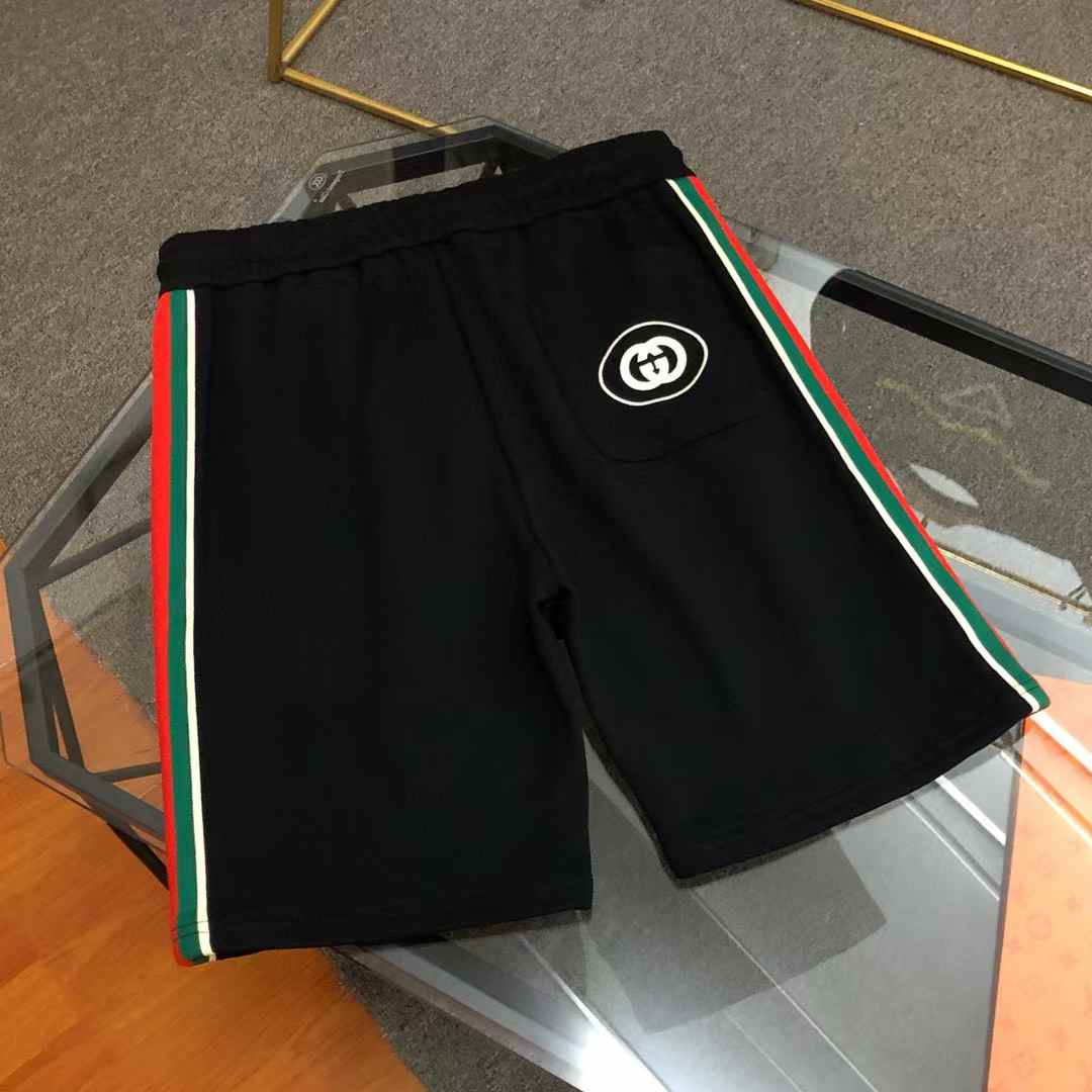Gucci technical jersey shorts in black with the signature green and red Web stripes down the sides and an interlocking G logo
