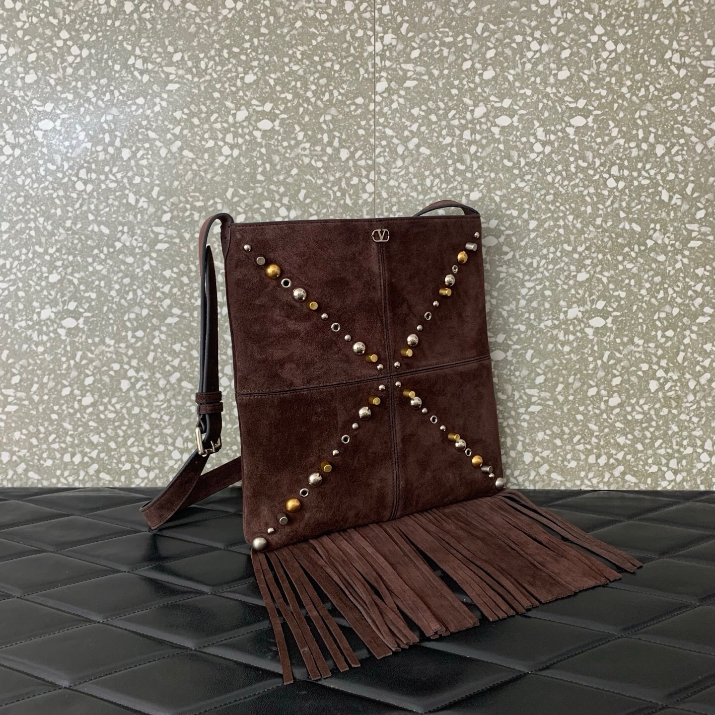 Valentino Garavani Nellcôte small shoulder bag in brown suede with fringes and studs of various shapes and sizes