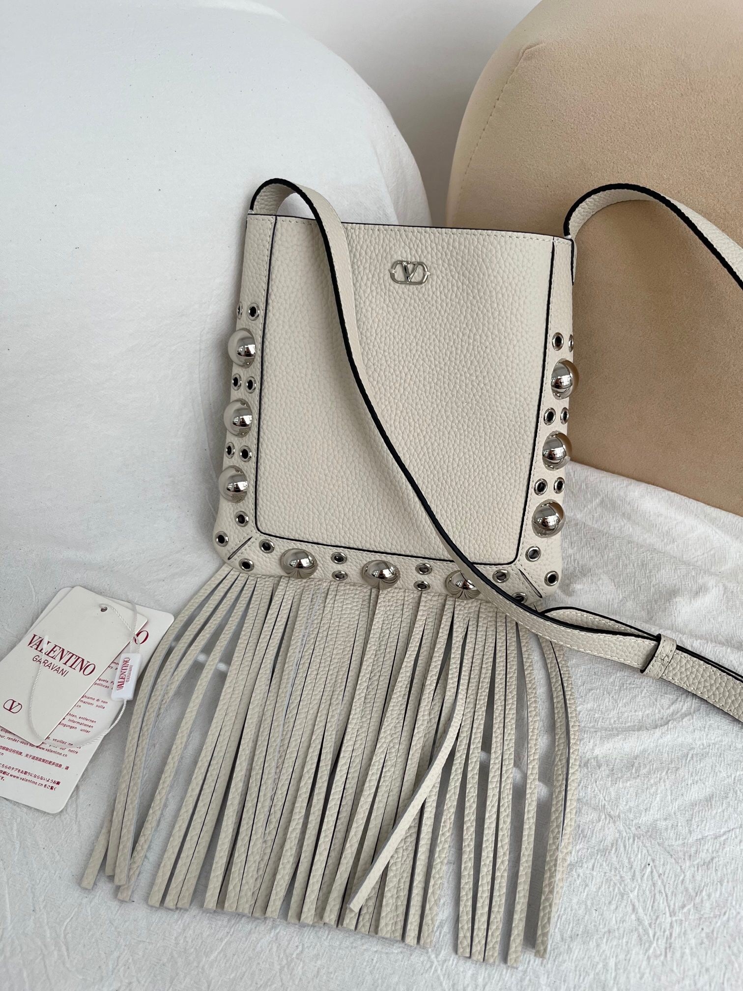 Valentino Garavani Nellcôte small fringe studded leather crossbody bag in light ivory