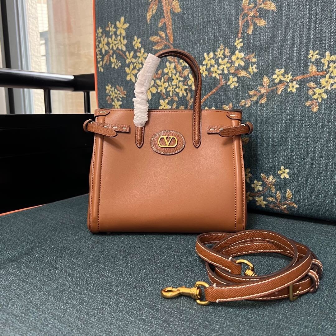 Valentino Garavani Antibes small leather tote bag in a brown/tobacco color