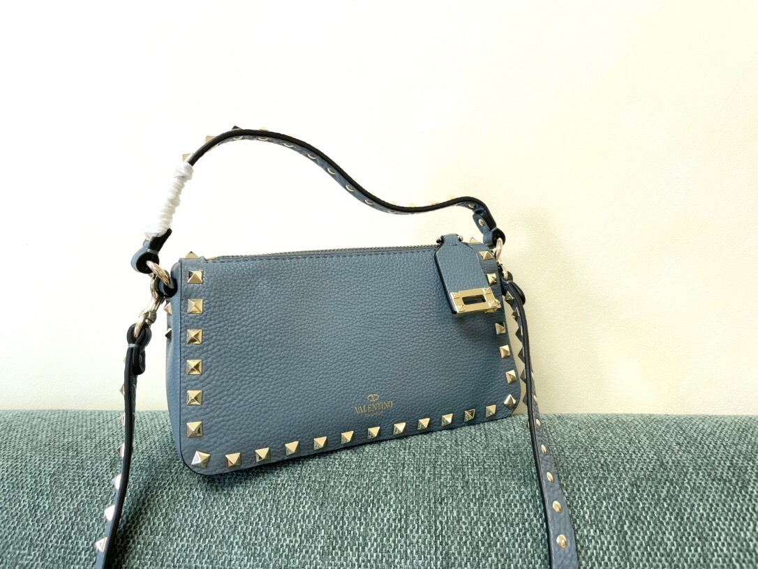 Valentino Garavani Rockstud small zipped crossbody bag in blue grained calf leather with gold-tone hardware and studs