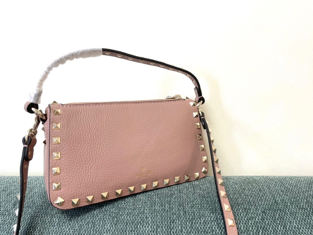 Valentino Garavani Small Rockstud crossbody bag in grainy calfskin leather with platinum-finished studs and a top handle