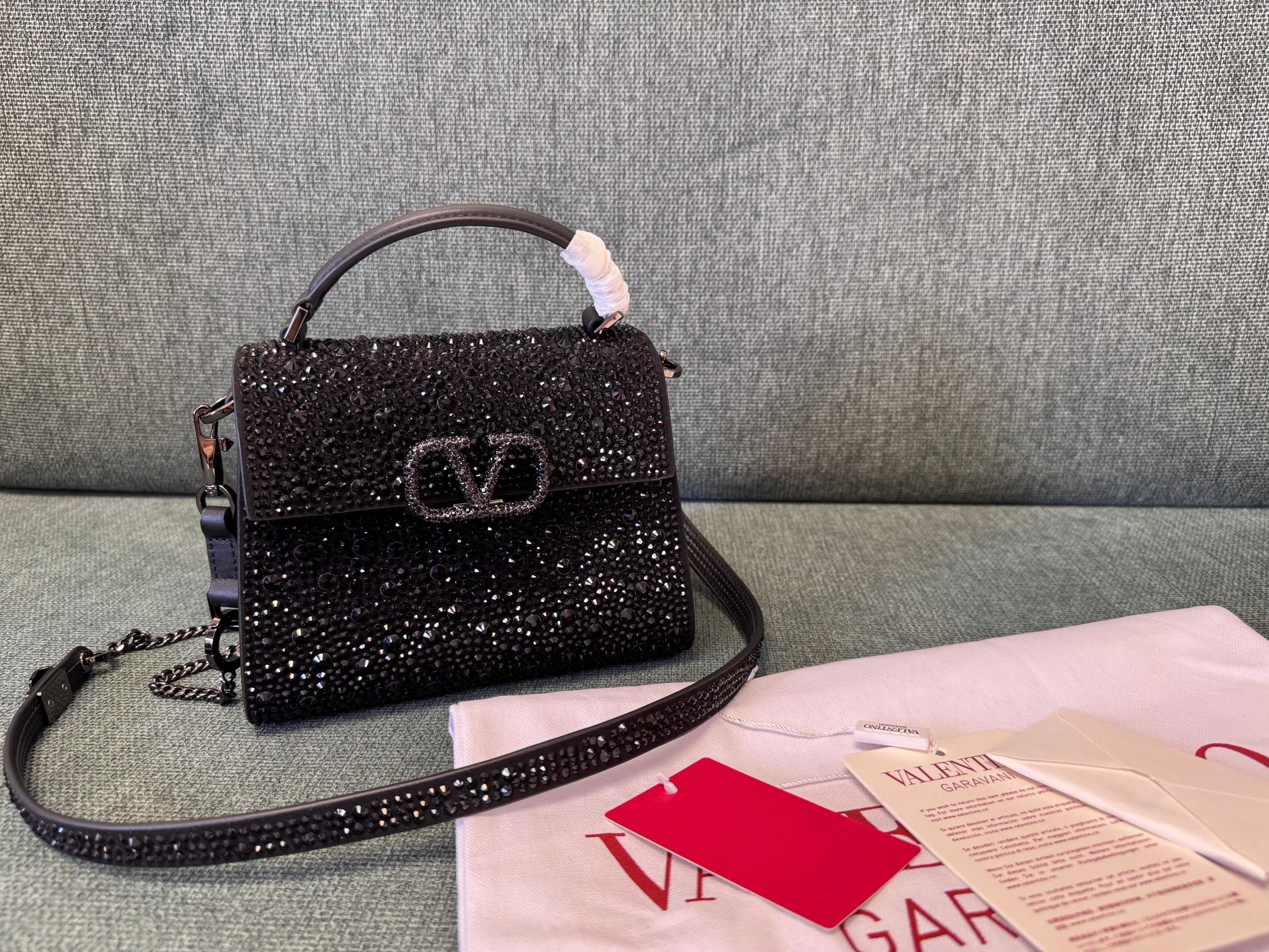 Valentino Garavani VSling mini handbag covered in black glass crystals
