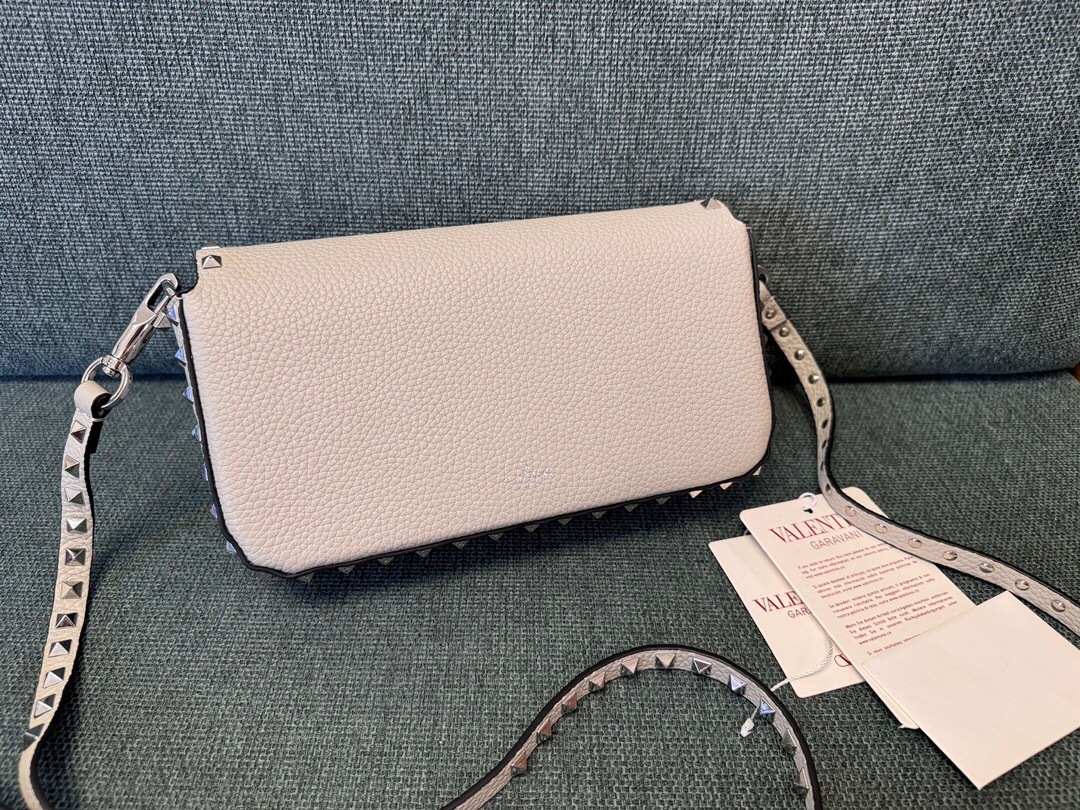 Valentino Garavani Rockstud small crossbody bag in ivory grained calfskin leather with platinum-finish metal studs