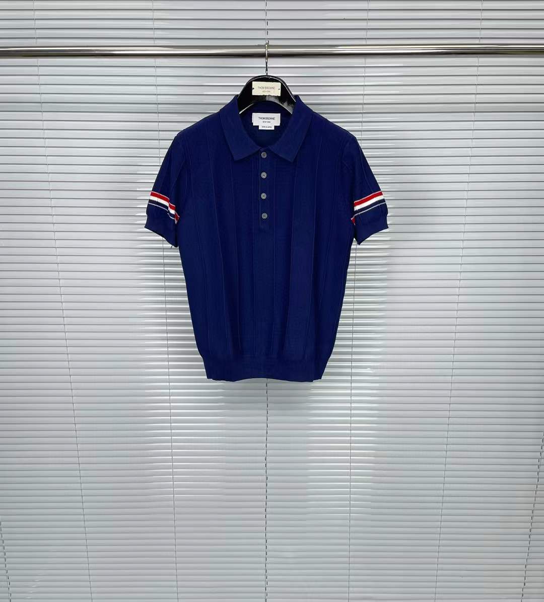 Thom Browne striped cotton polo shirt in navy blue with the signature 4-bar stripes on the sleeve cuffs