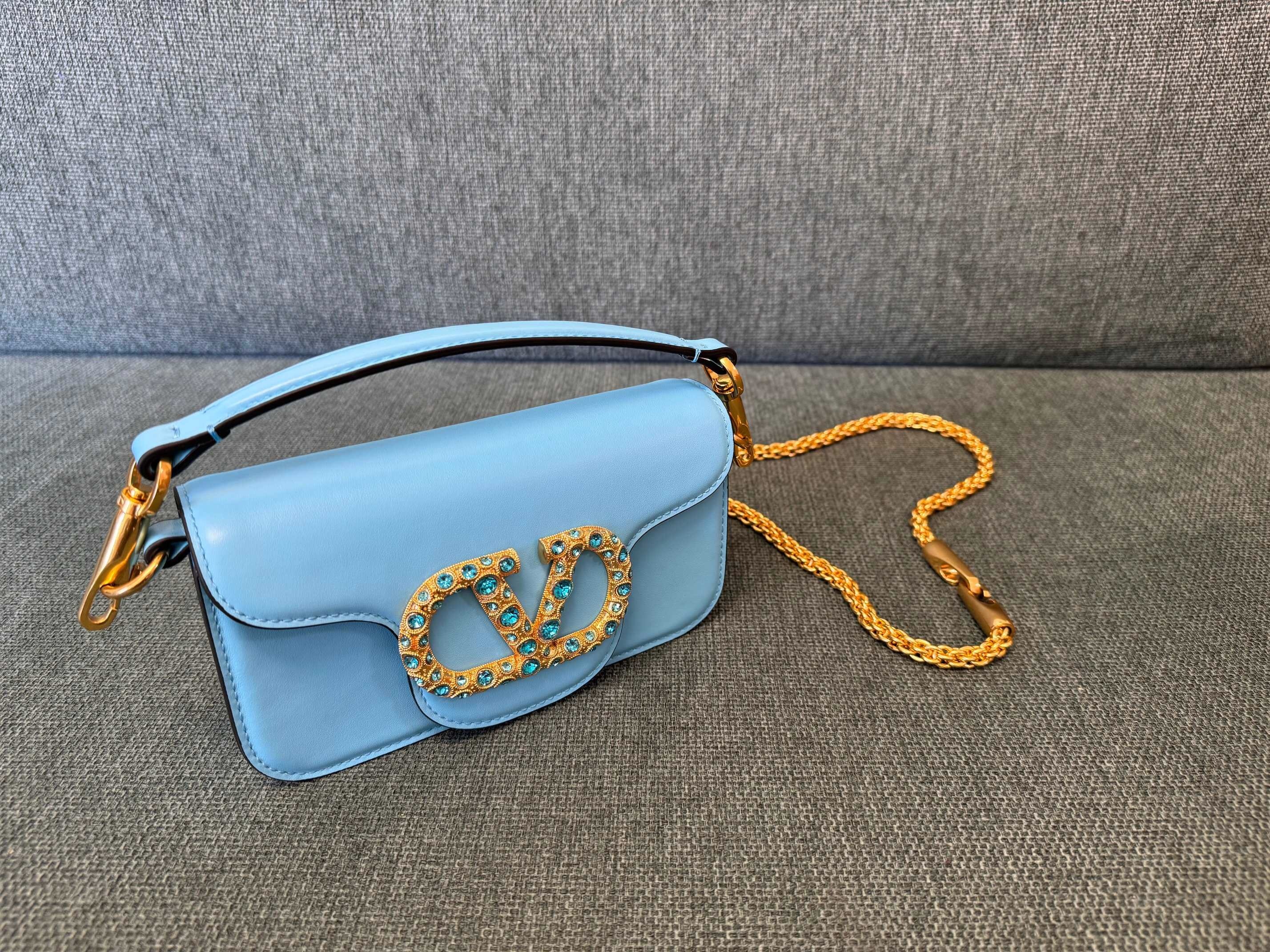 Valentino Garavani Locò small shoulder bag in light blue calfskin leather with a VLogo Signature jewel element decorated with Swarovski crystals