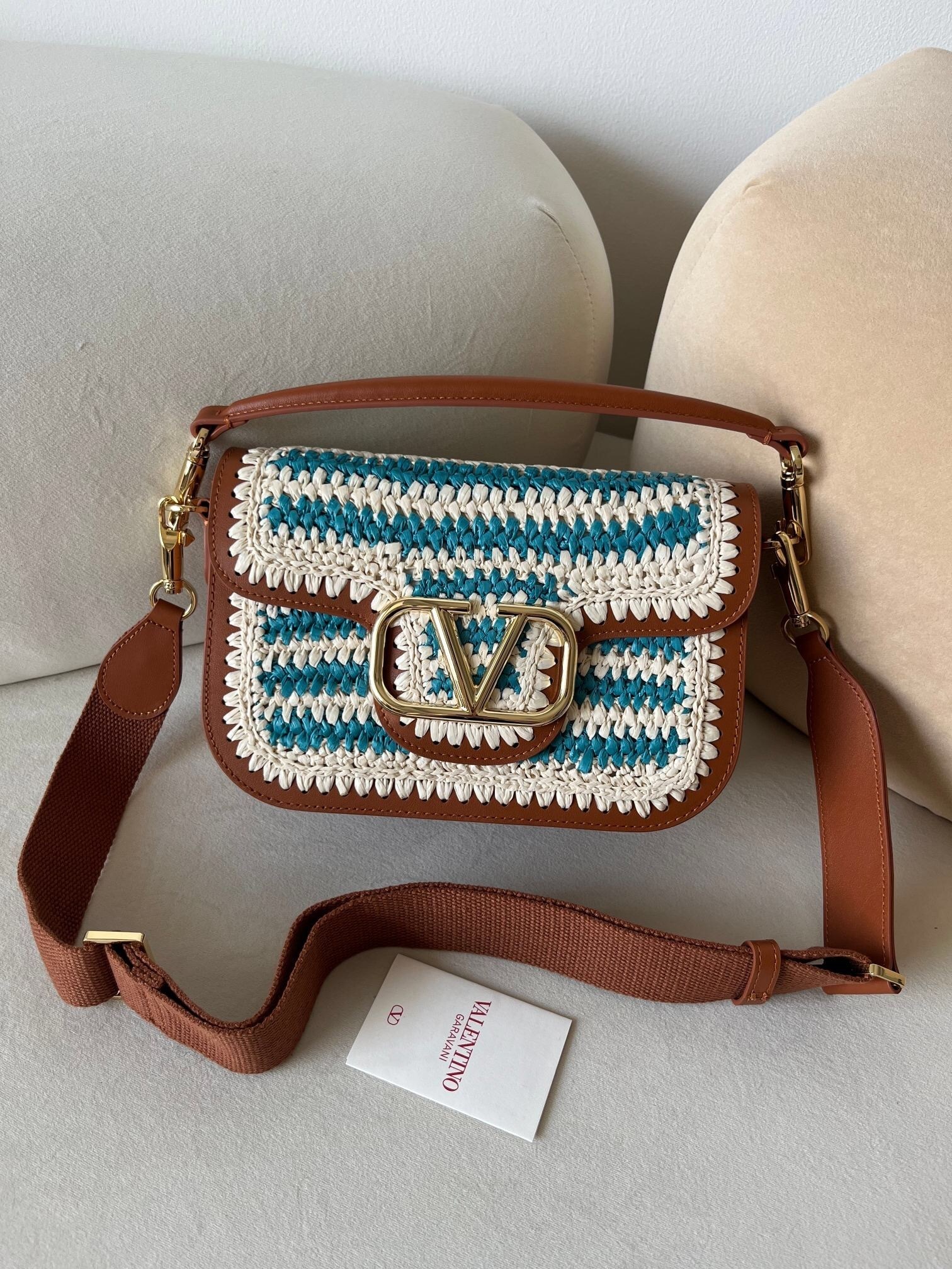 Valentino Garavani Alltime VLOGO Flap Crochet Shoulder Bag in a white and teal crochet material with brown leather trim