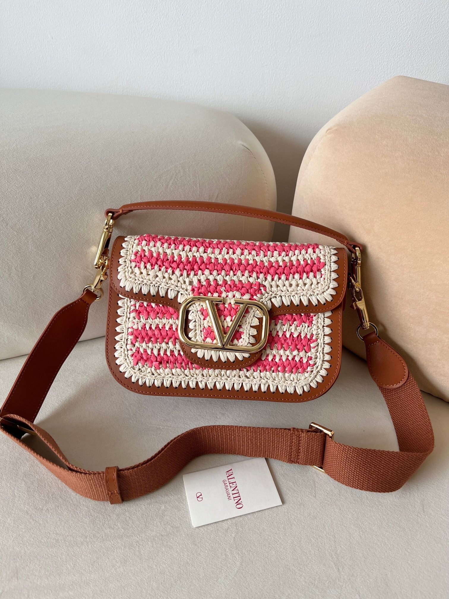 Valentino Garavani Alltime small raffia and leather shoulder bag with a pink and white woven body and brown leather trim