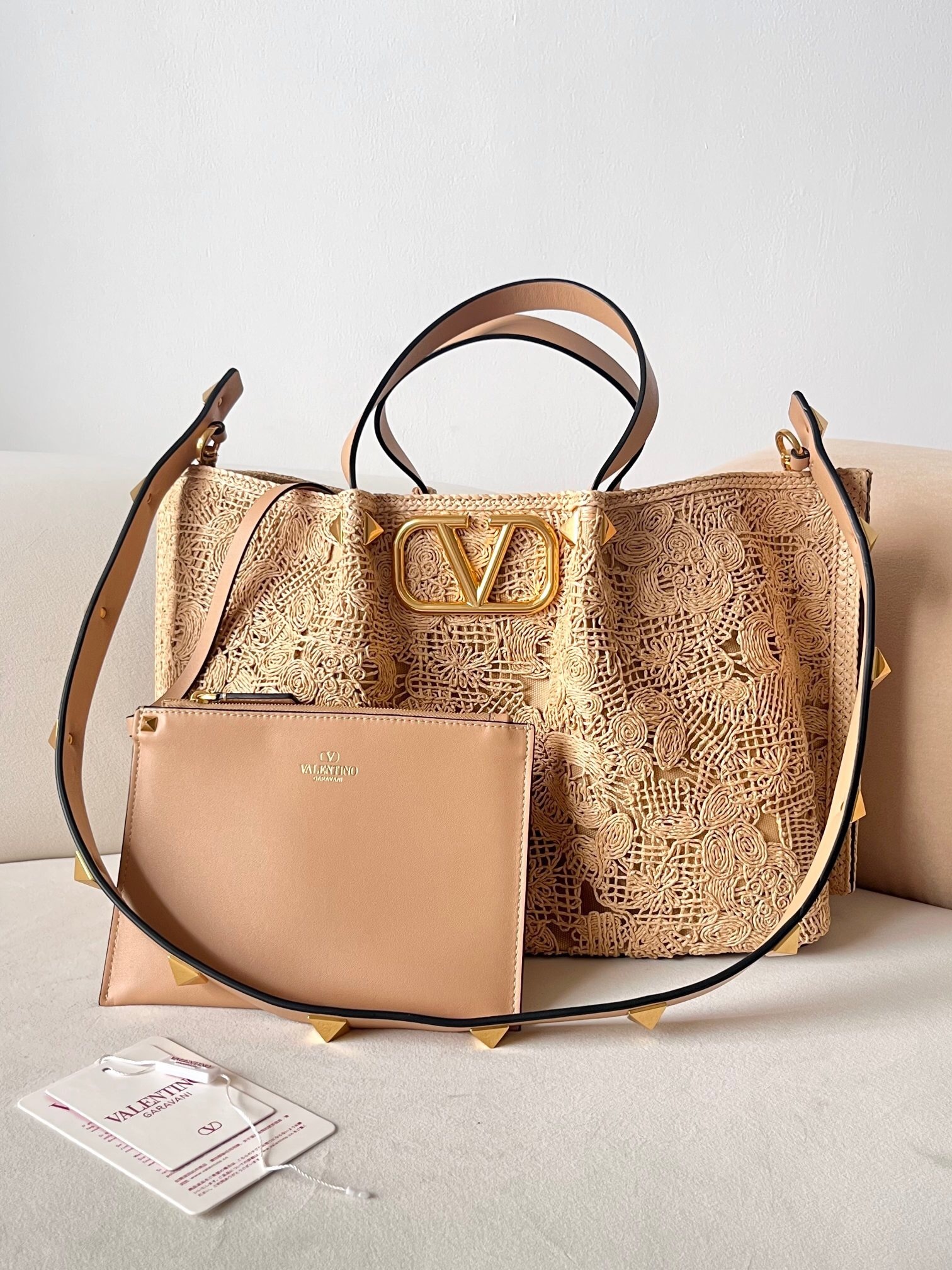 Valentino Garavani VLogo Signature raffia tote bag in a natural/neutral color with a lace-effect design and leather trim