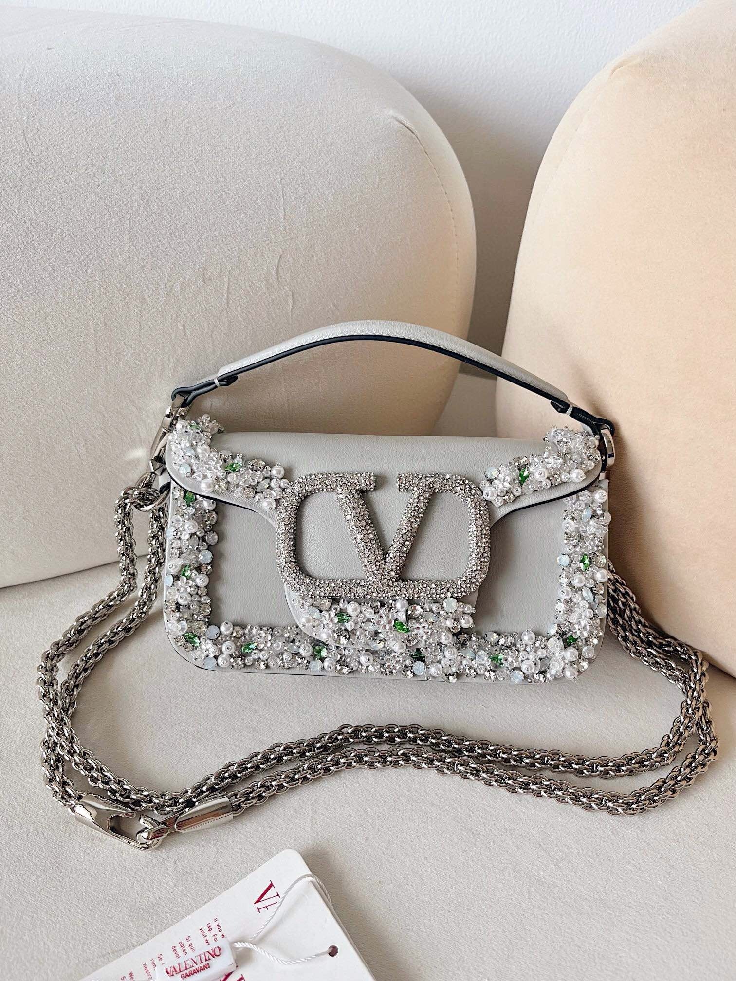 Valentino Garavani Locò small shoulder bag in calfskin with a VLogo Signature element covered with Swarovski crystals and embellished with crystal and pearl details
