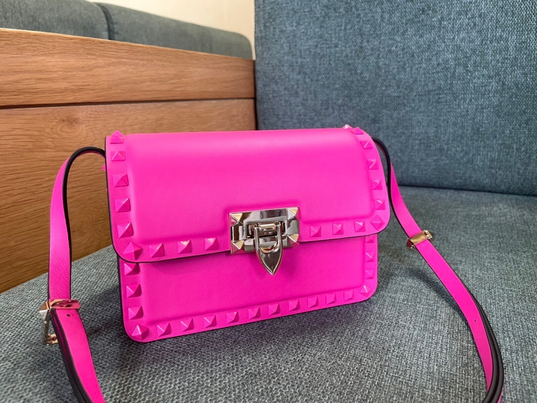 Valentino Garavani Rockstud23 shoulder bag in a vibrant pink color and smooth calfskin leather