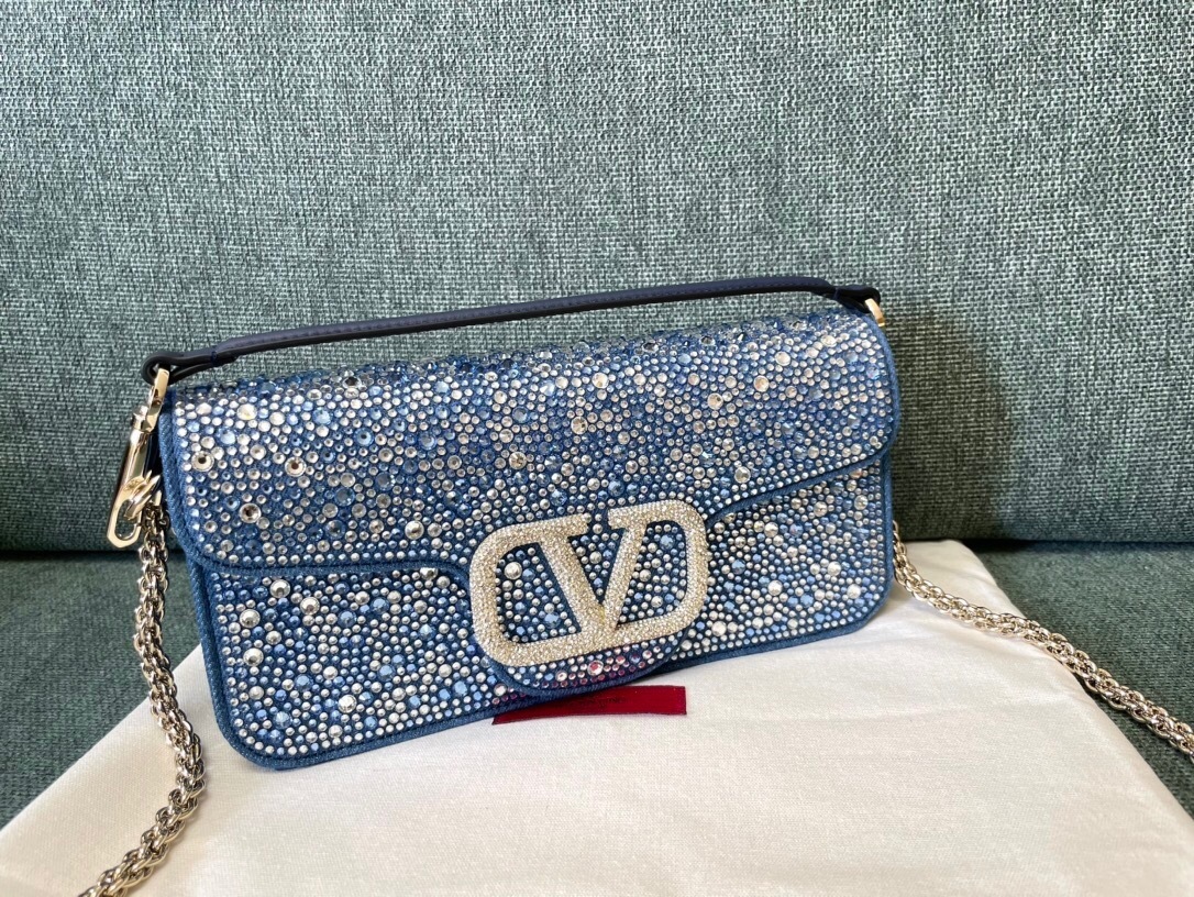 Valentino Garavani Locò shoulder bag in blue with crystal embellishments and silver-tone hardware.