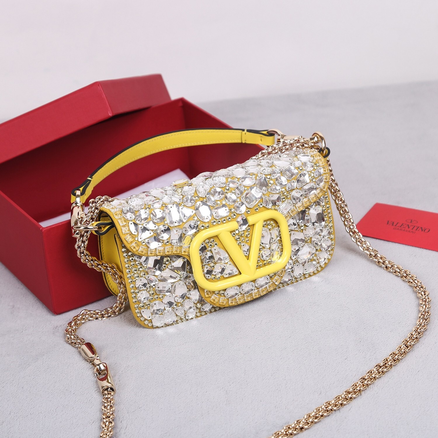 Valentino Garavani crystal-embellished shoulder bag with a yellow leather strap and gold-tone hardware