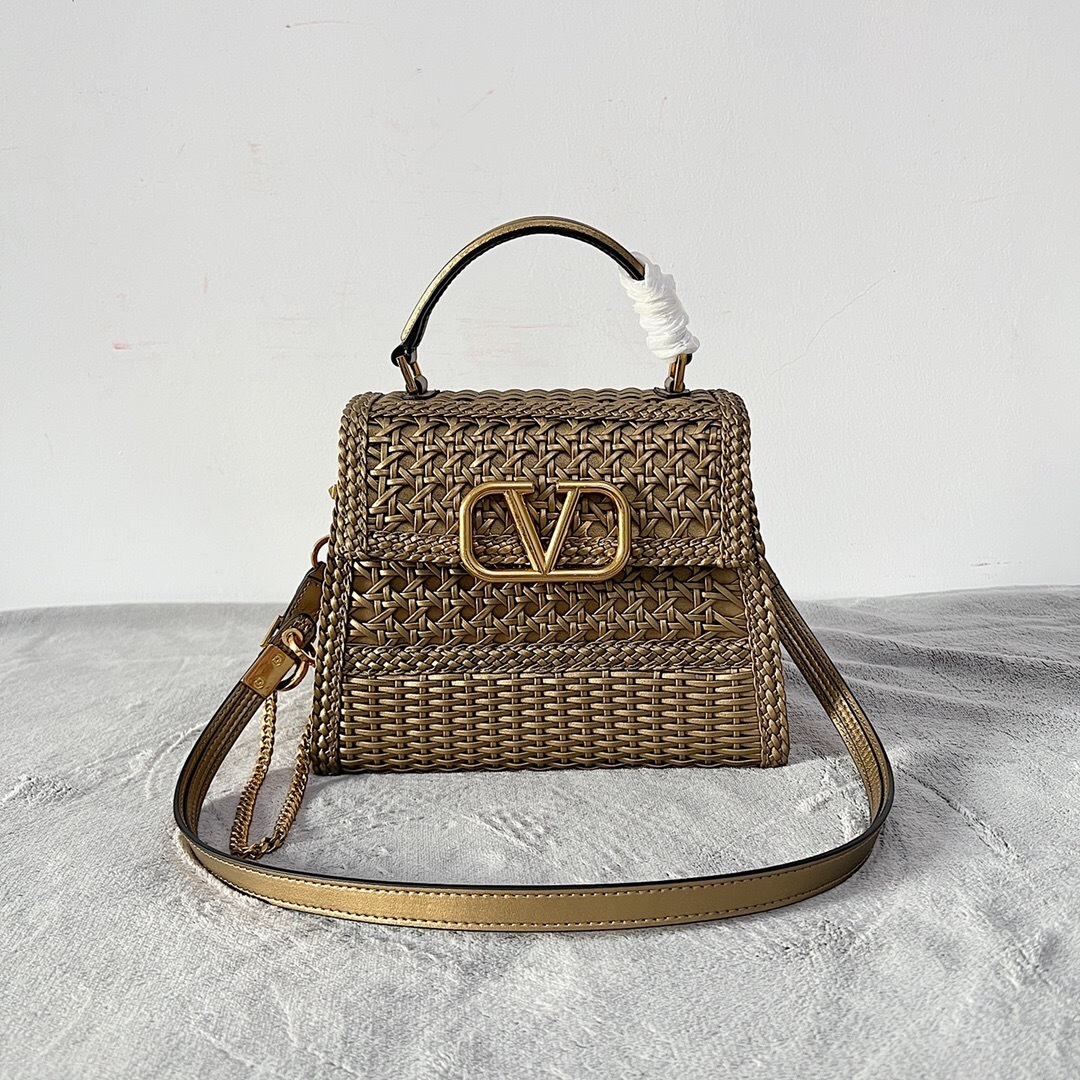 Valentino Garavani VSLING small top-handle bag in a metallic woven material