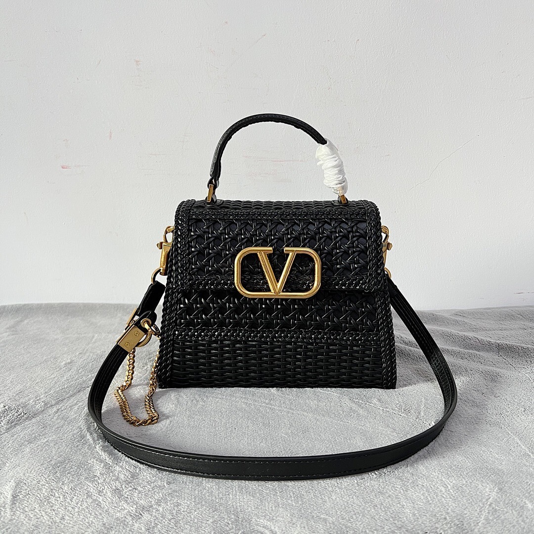 Valentino Garavani VSLING small handbag in black with a woven/braided exterior texture and gold-tone VLogo Signature hardware