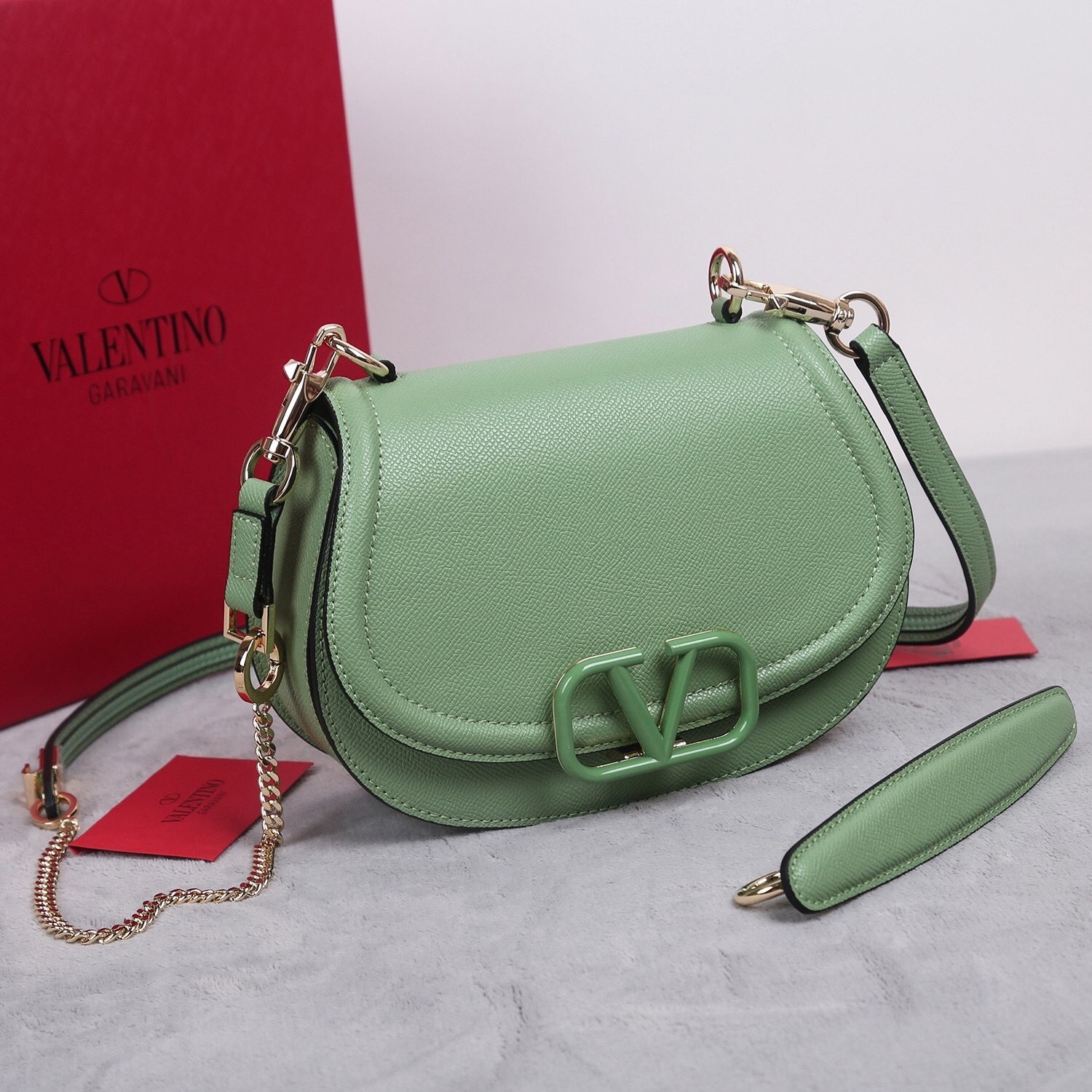 Valentino Garavani VSling shoulder bag in grainy calfskin leather with a green enamel VLogo Signature closure