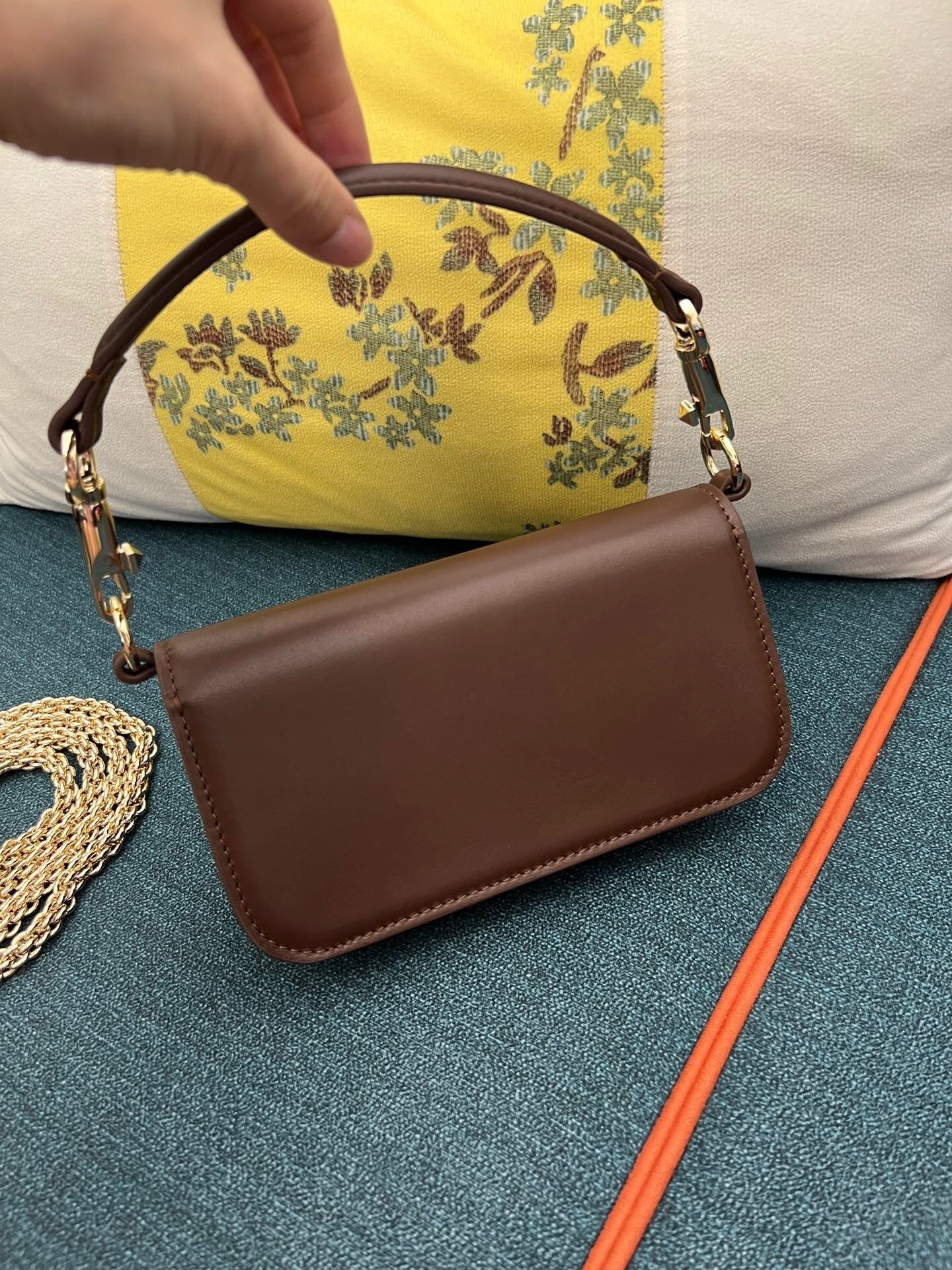 Valentino Garavani Locò small shoulder bag in brown calfskin leather with a VLogo Signature metallic element