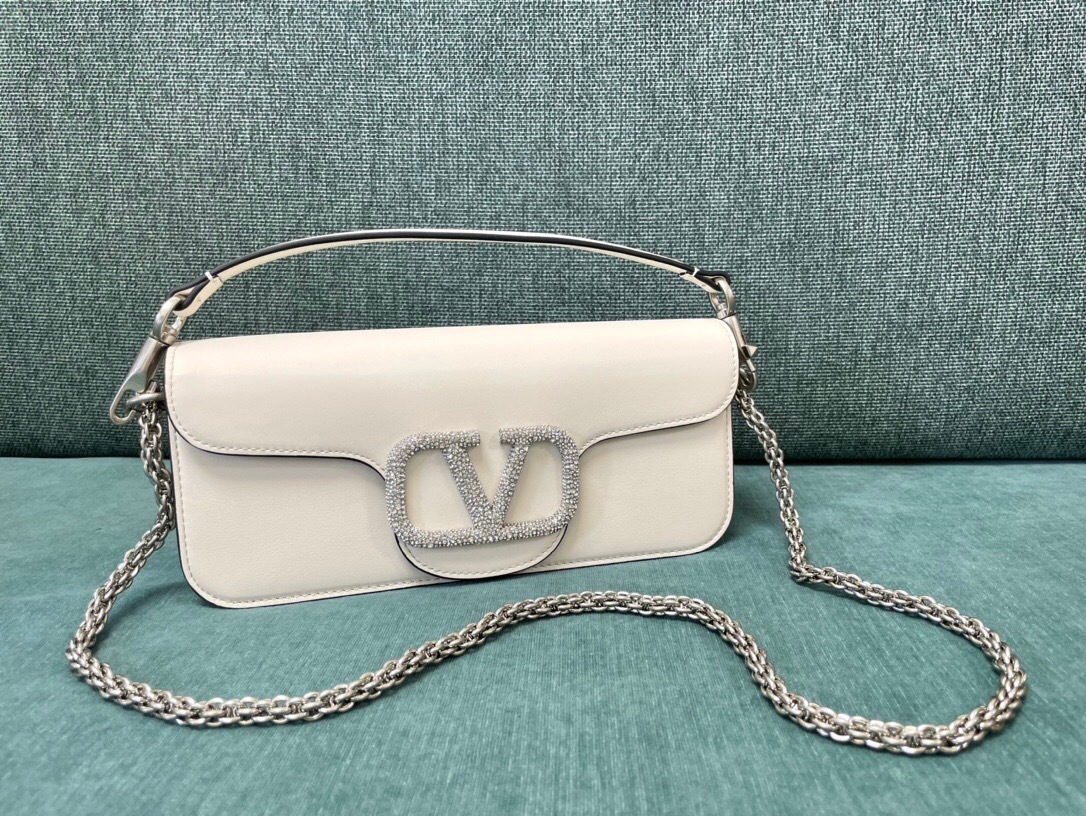 Valentino Garavani VLogo Signature shoulder bag in white leather with a crystal-embellished logo and a chain strap