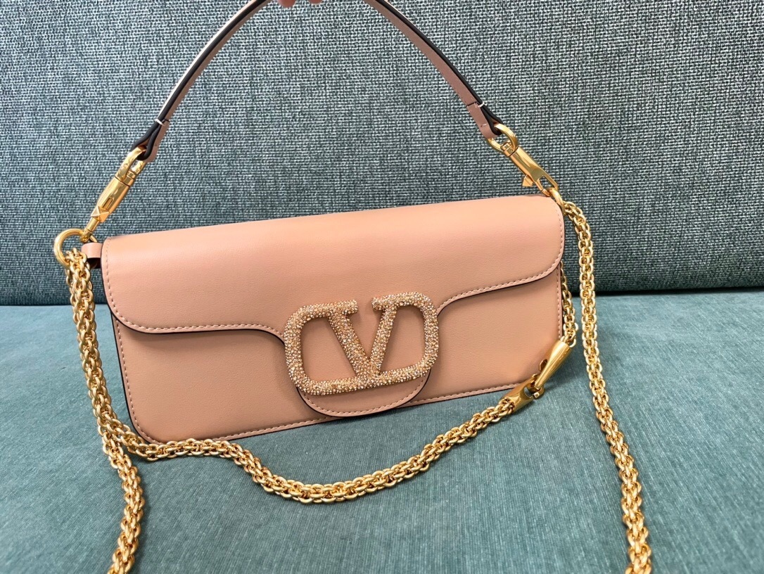 Valentino Garavani Locò small shoulder bag in calfskin with a VLogo Signature element covered in Swarovski crystals