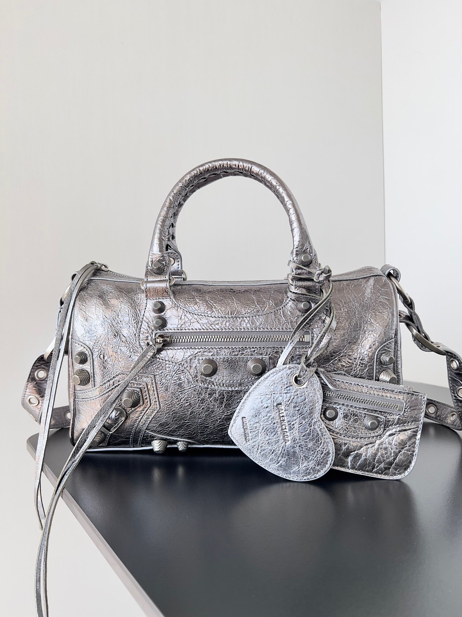 Balenciaga Le Cagole Mini Duffle Bag crafted from crinkled metallic lambskin leather with aged-silver hardware